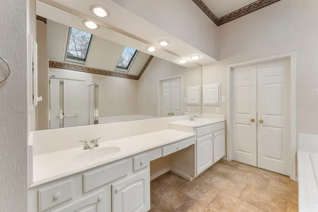 a bathroom with a sink double vanity and a mirror