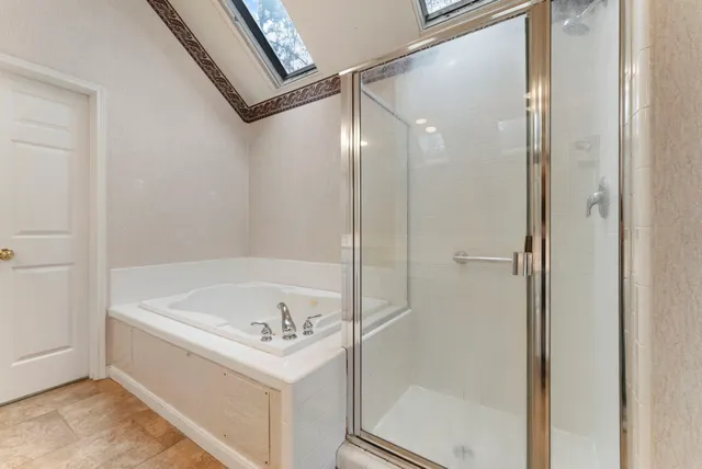 a bathroom with a bathtub and a shower