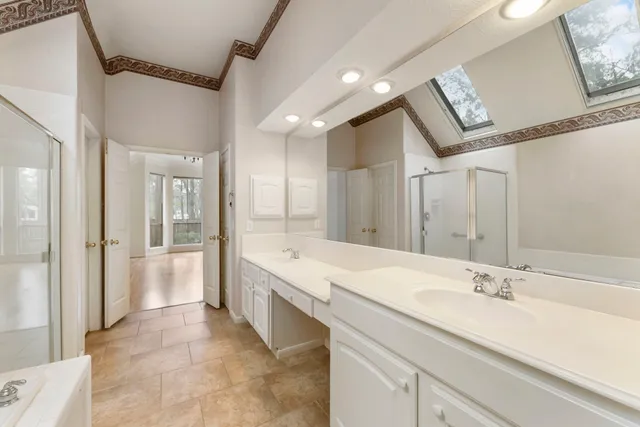 a spacious bathroom with a granite countertop sink mirror and bathtub