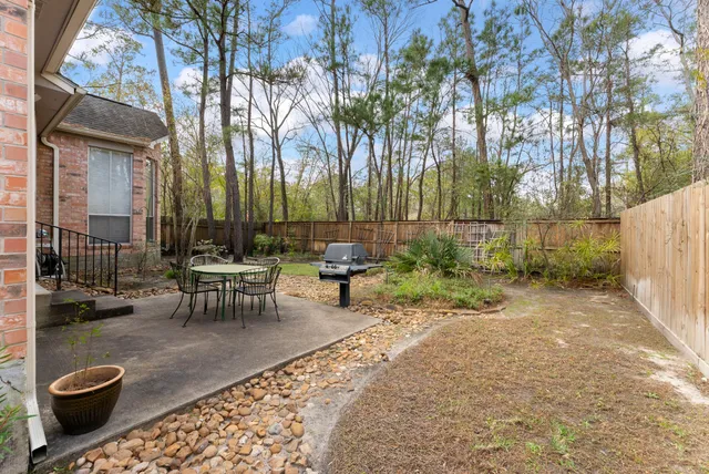 a white house that has a tree in front of it