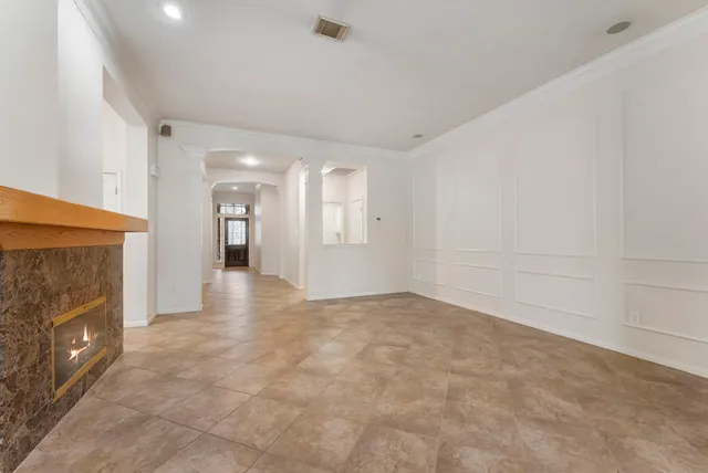 a view of an empty room with a fireplace