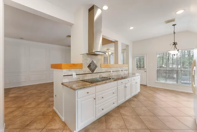 a bathroom with a granite countertop sink a toilet a mirror and shower