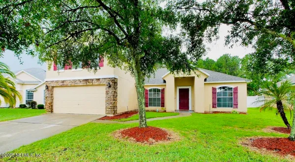 a house that has a tree in front of it