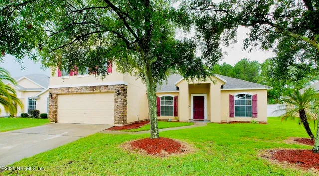 a house that has a tree in front of it