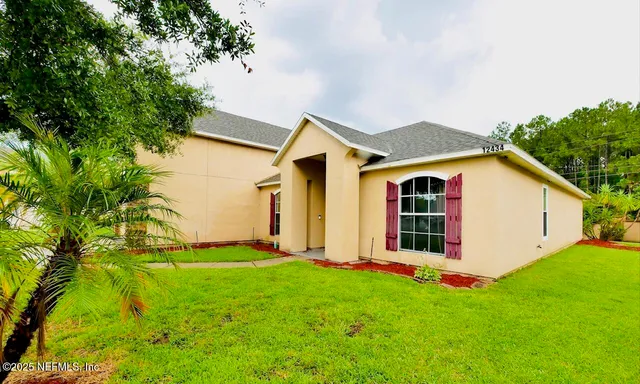 a kitchen with stainless steel appliances granite countertop a refrigerator and a stove