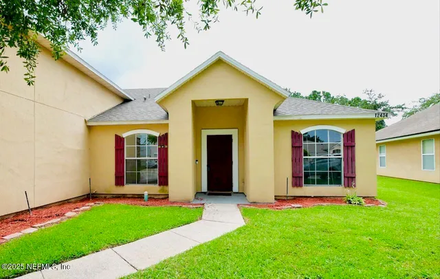 a view of a livingroom with a flat screen tv and wooden floor