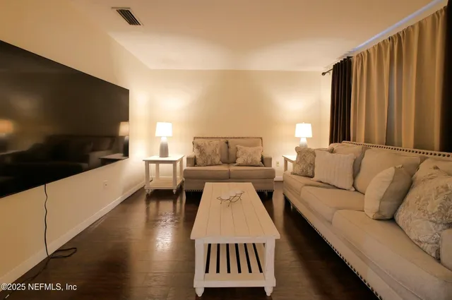 a view of a livingroom with a ceiling fan and window