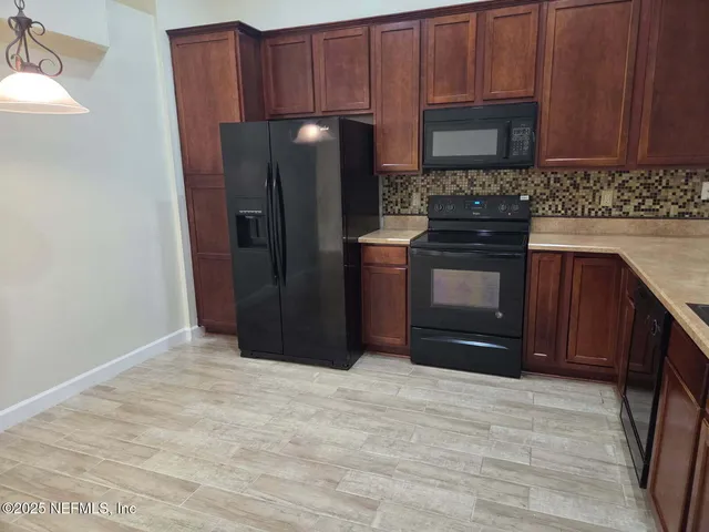 a view of a room with gym equipment and white walls