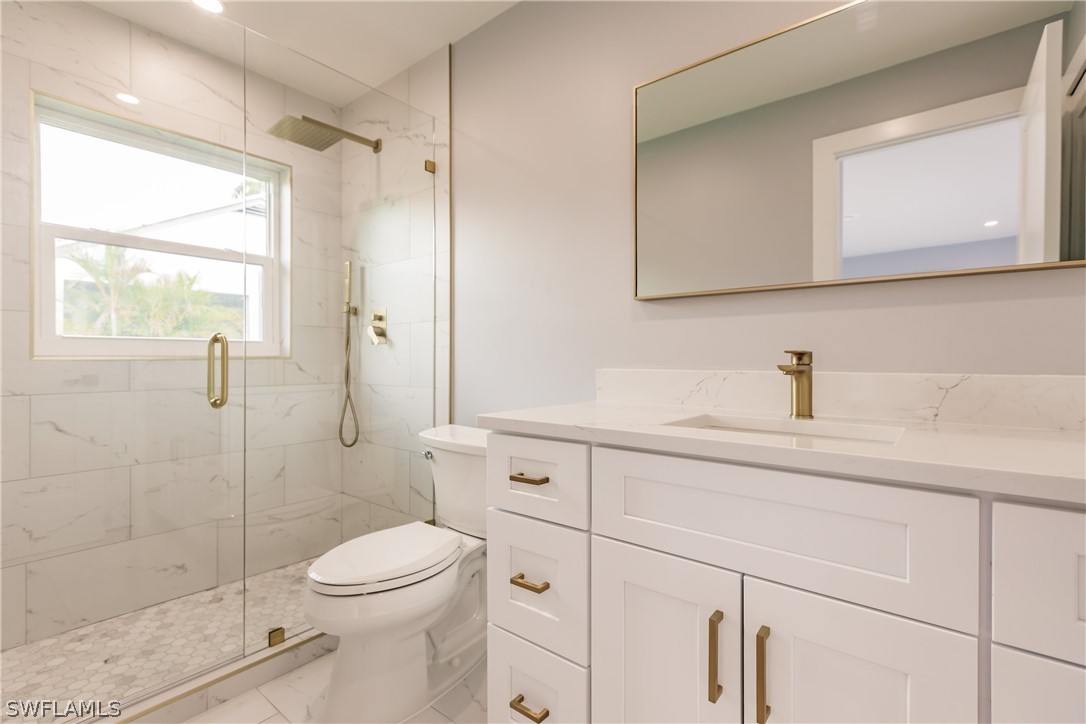 1623 Coronado Road Fort Myers, FL 33901 - Photo 11 of 24 a bathroom with a sink a toilet and shower