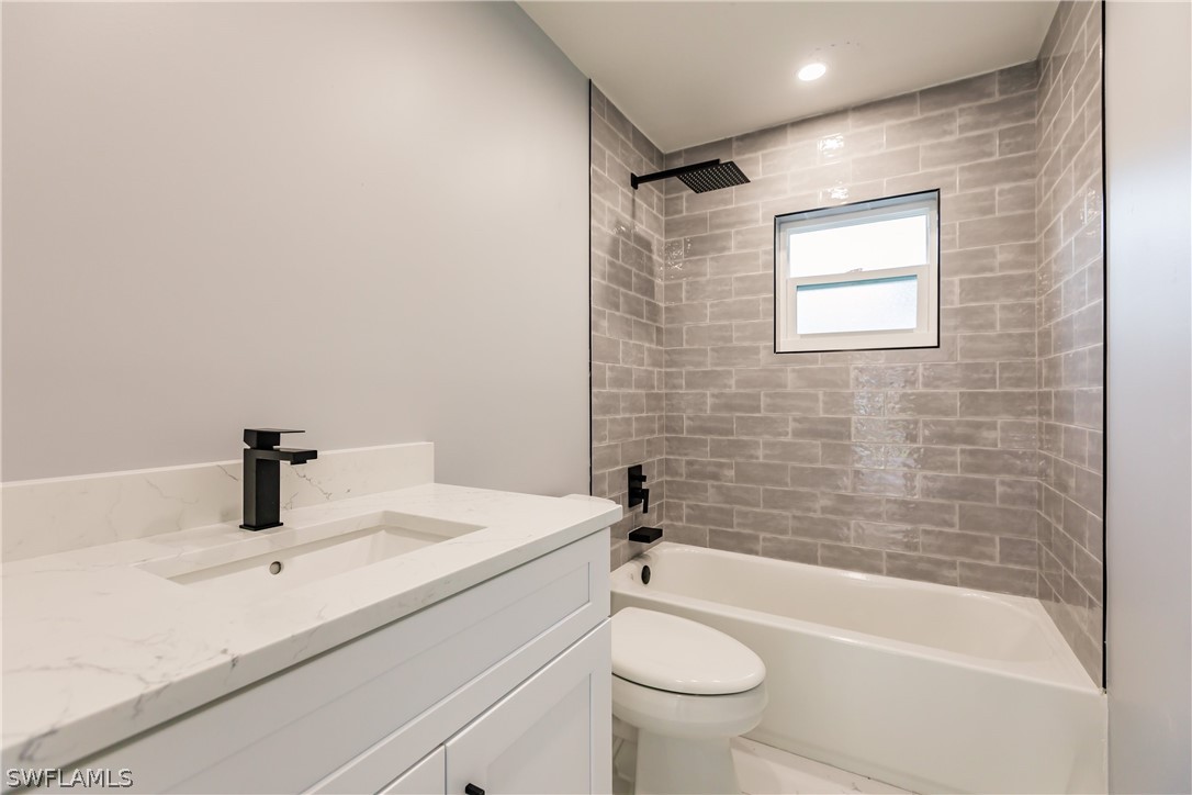 1623 Coronado Road Fort Myers, FL 33901 - Photo 12 of 24 a bathroom with a sink mirror toilet and bathtub