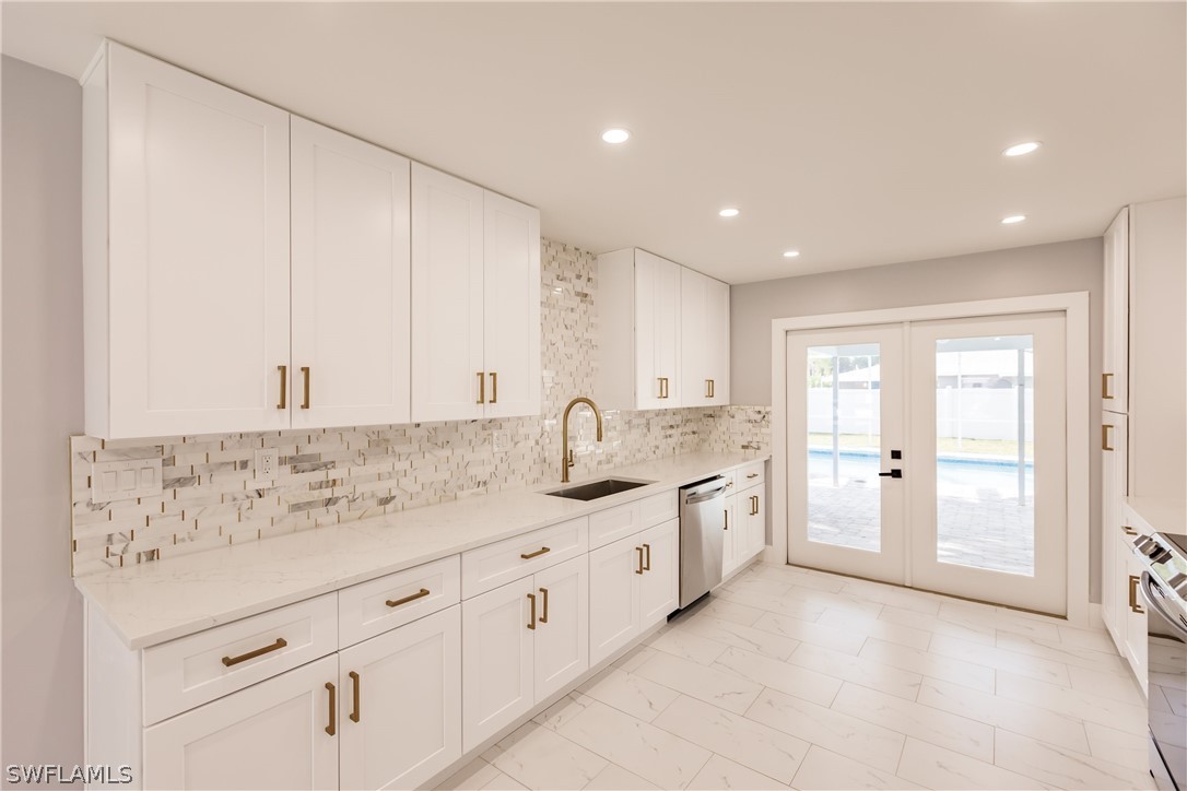 1623 Coronado Road Fort Myers, FL 33901 - Photo 5 of 24 a spacious bathroom with a granite countertop sink and a mirror