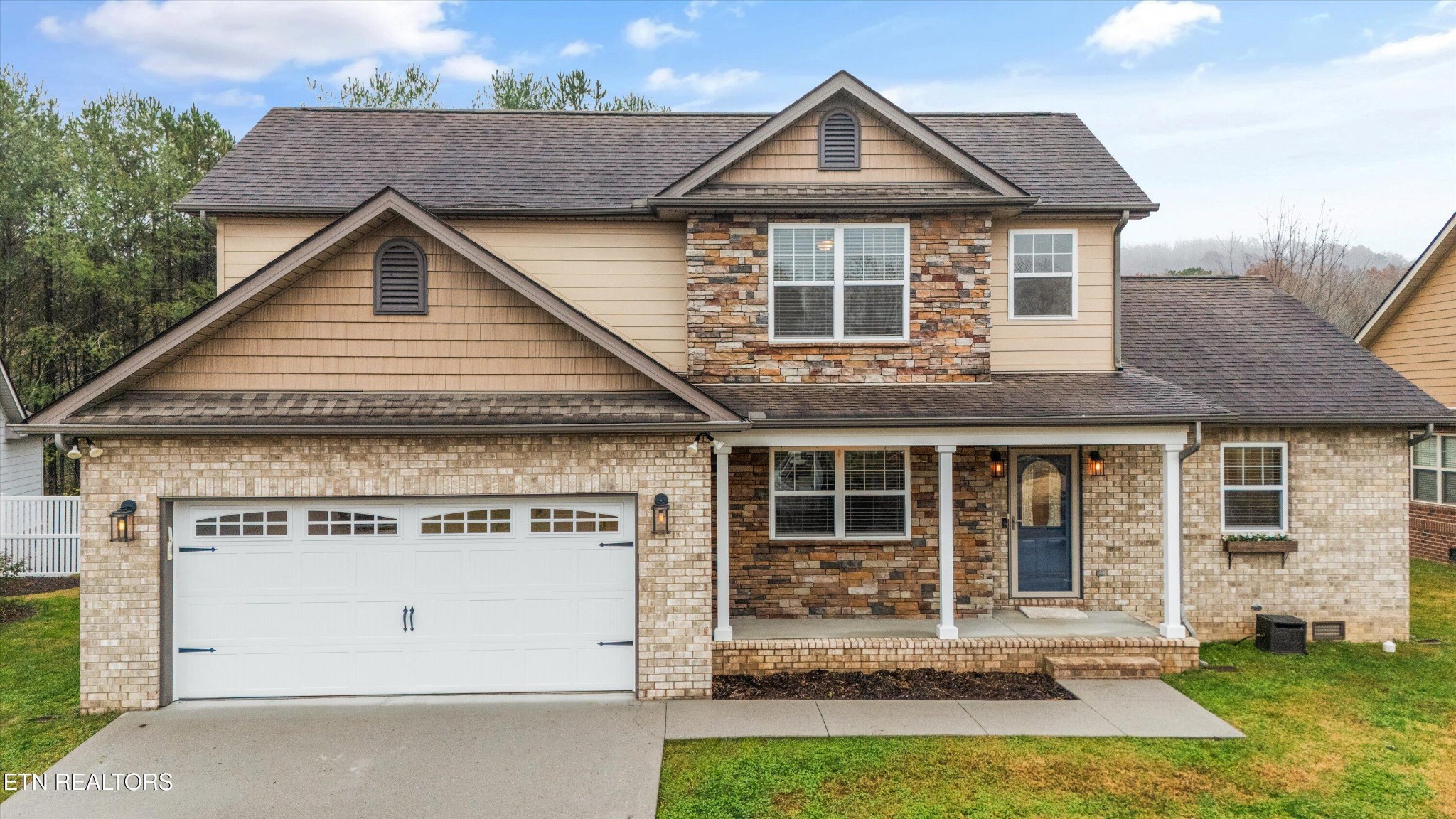 a front view of a house with a yard