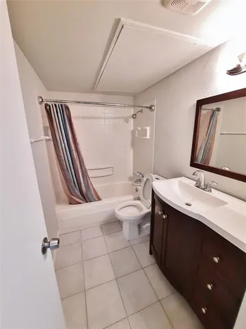 a bathroom with a double vanity sink toilet mirror and tub