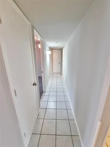 a view of a livingroom with an empty space and a window