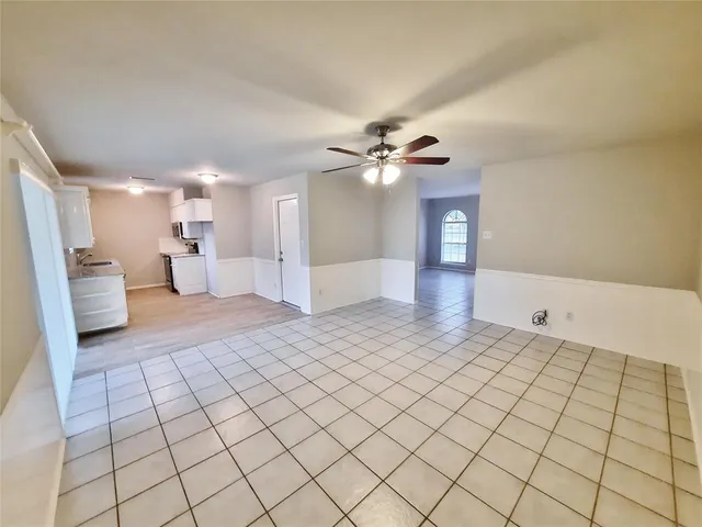 a view of an empty room and a bathroom
