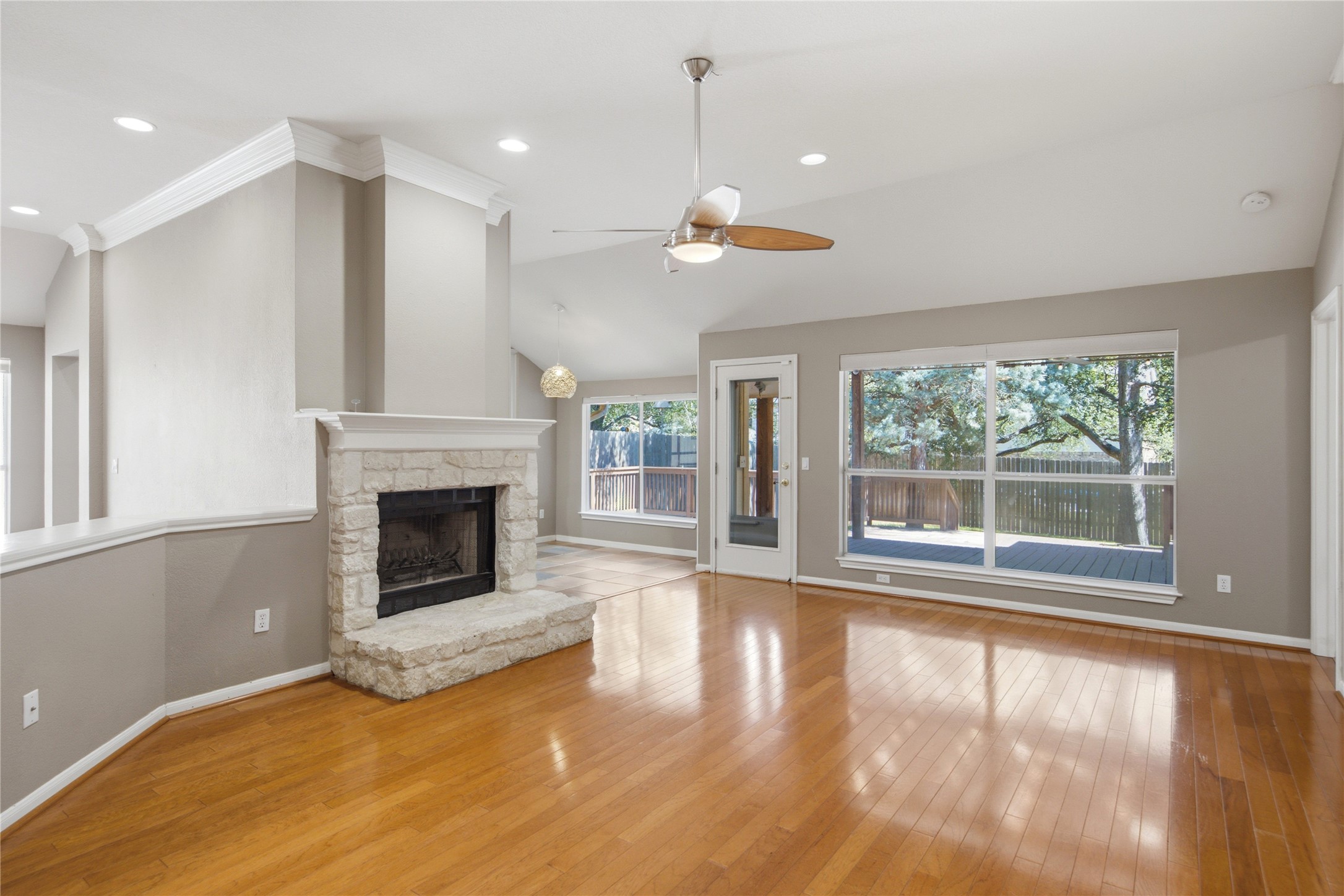6032 Roxbury Lane Austin, TX 78739 - Photo 5 of 34 Gleaming hardwood floors and a stone fireplace anchor this airy, open living space.