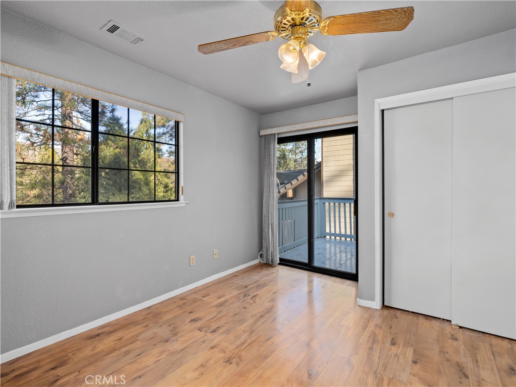 40557 Saddleback Road Bass Lake, CA 93604 - Photo 13 of 31 a view of an empty room with a window and wooden floor