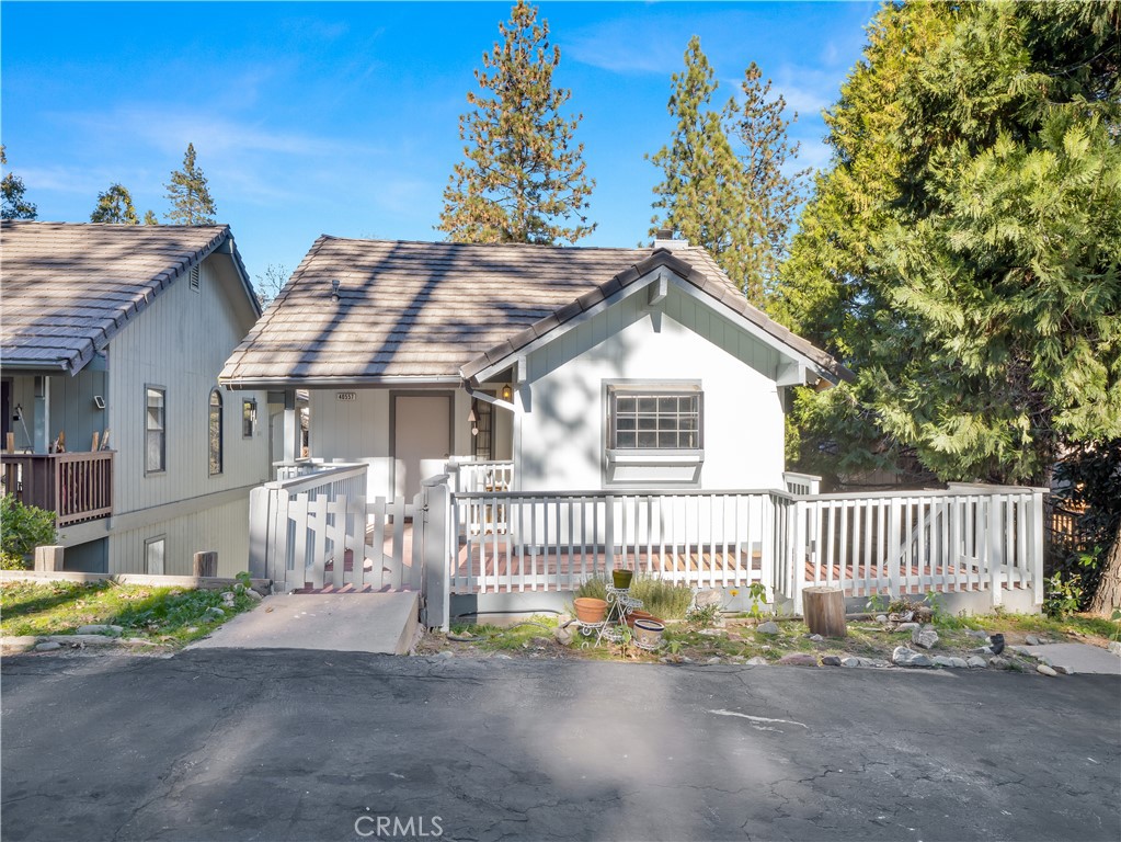 40557 Saddleback Road Bass Lake, CA 93604 - Photo 2 of 31 a view of a house with a small yard and wooden fence