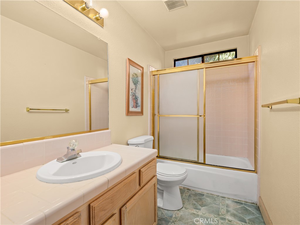 40557 Saddleback Road Bass Lake, CA 93604 - Photo 21 of 31 a bathroom with a sink toilet and shower