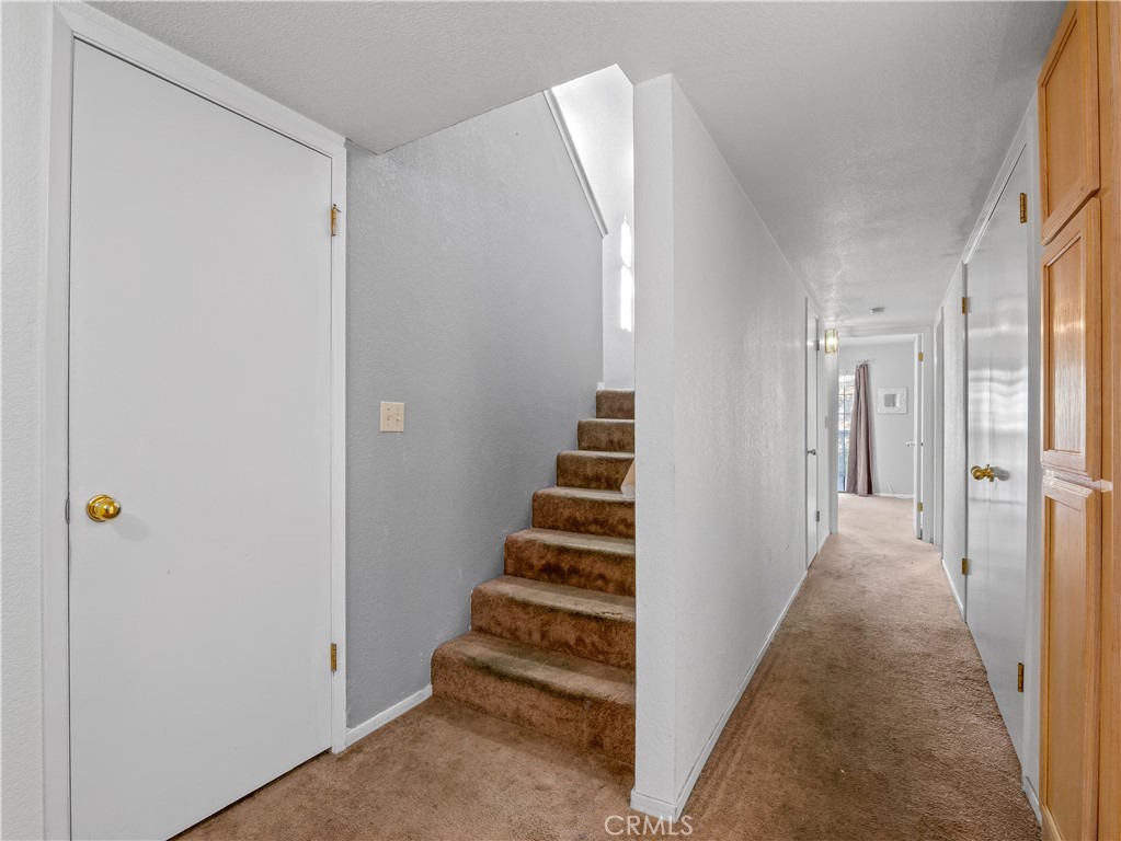 40557 Saddleback Road Bass Lake, CA 93604 - Photo 22 of 31 a view of a hallway with stairs
