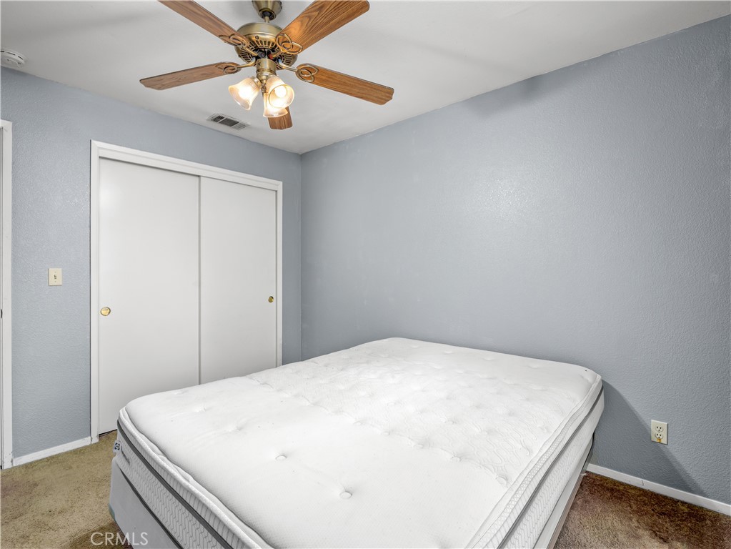 40557 Saddleback Road Bass Lake, CA 93604 - Photo 25 of 31 a bed sitting in a bedroom next to a window and a chandelier