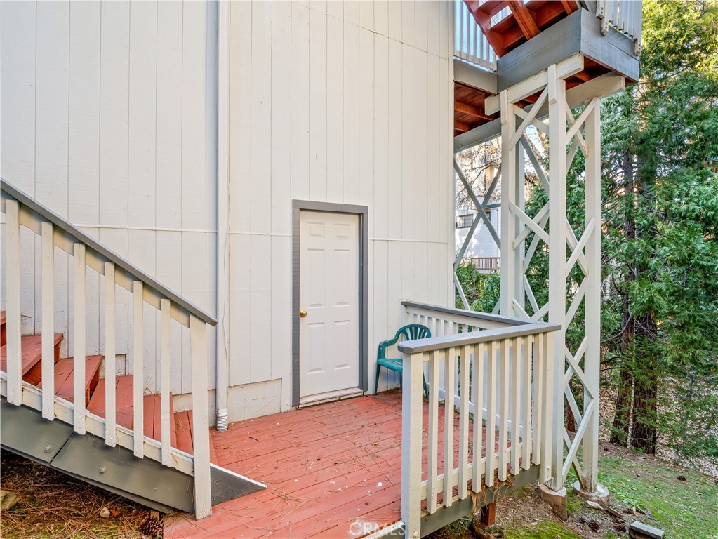 40557 Saddleback Road Bass Lake, CA 93604 - Photo 31 of 31 a view of a balcony with wooden floor and stairs