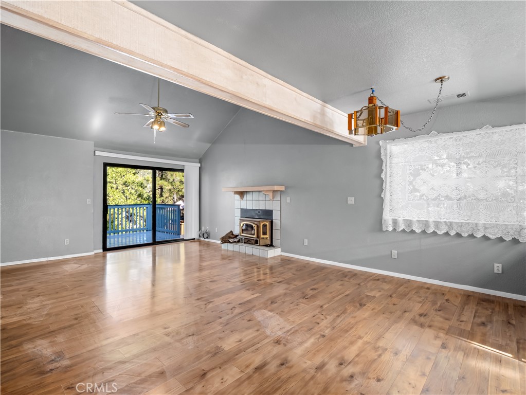 40557 Saddleback Road Bass Lake, CA 93604 - Photo 4 of 31 a view of an empty room with window and wooden floor
