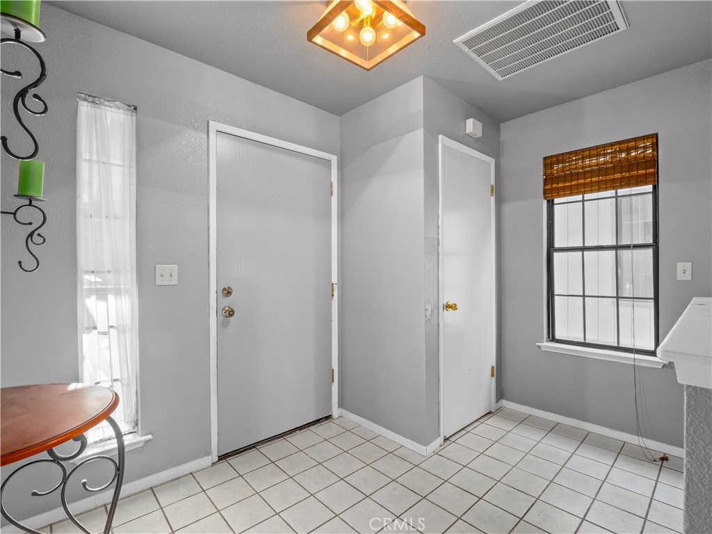 40557 Saddleback Road Bass Lake, CA 93604 - Photo 5 of 31 a view of an entryway with wooden floor and windows