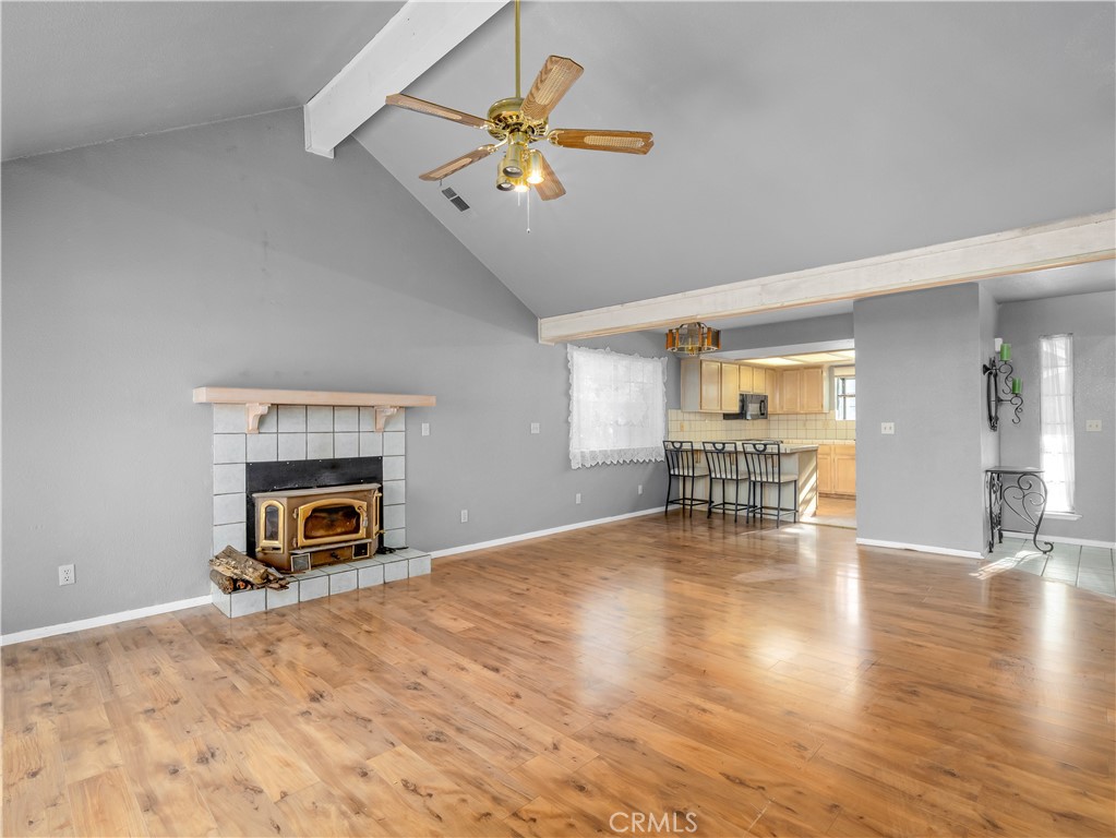40557 Saddleback Road Bass Lake, CA 93604 - Photo 7 of 31 a view of empty room with wooden floor and fireplace