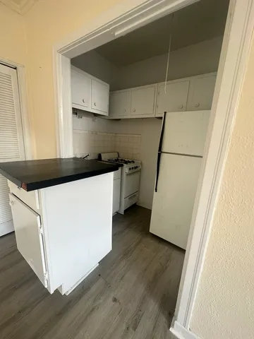 a utility room with wooden floor washer and dryer