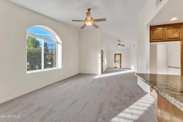 a kitchen with stainless steel appliances granite countertop a sink a stove and a refrigerator