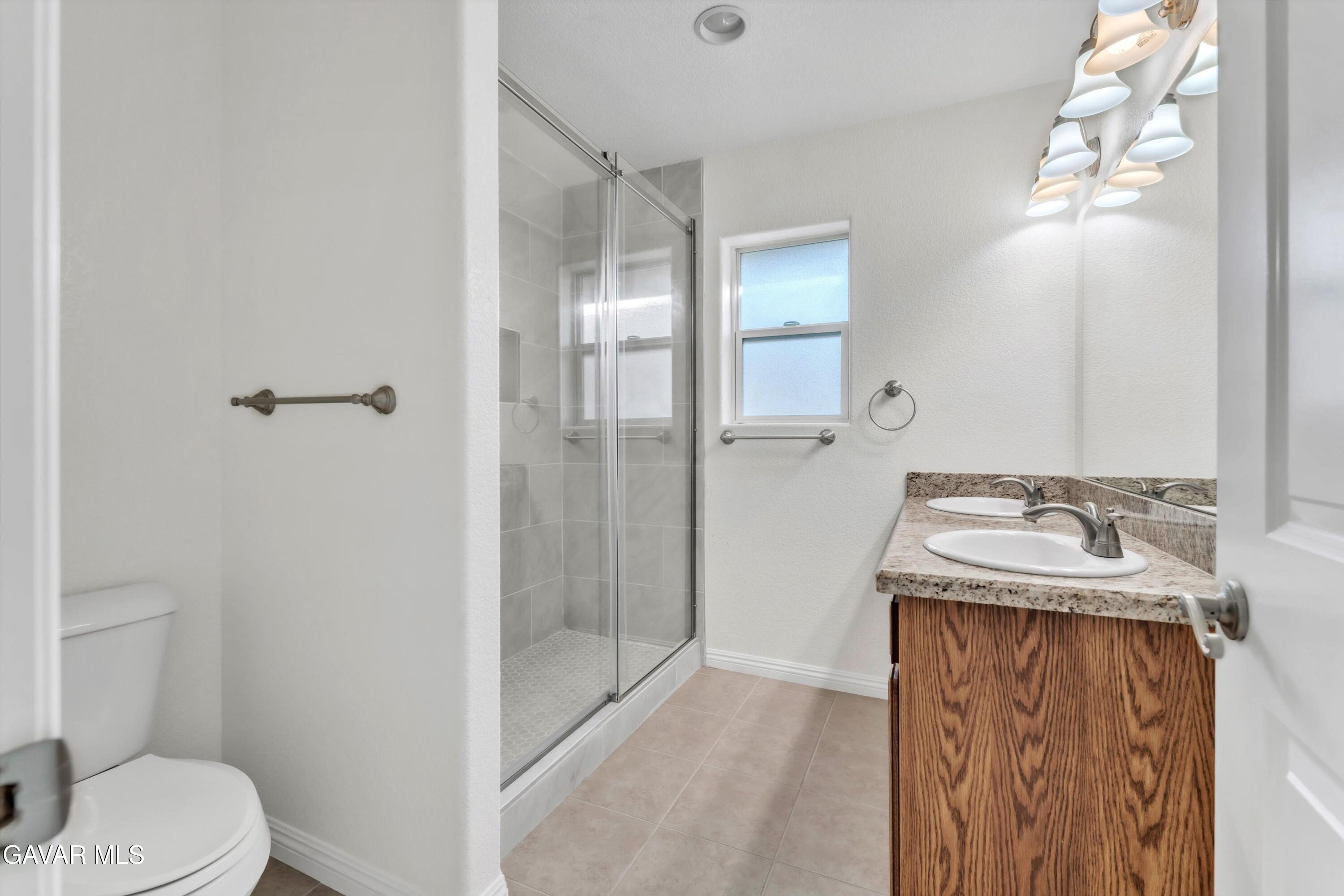 17819 Elizabeth Lake Road Lake Hughes, CA 93532 - Photo 19 of 28 a bathroom with a sink toilet and shower