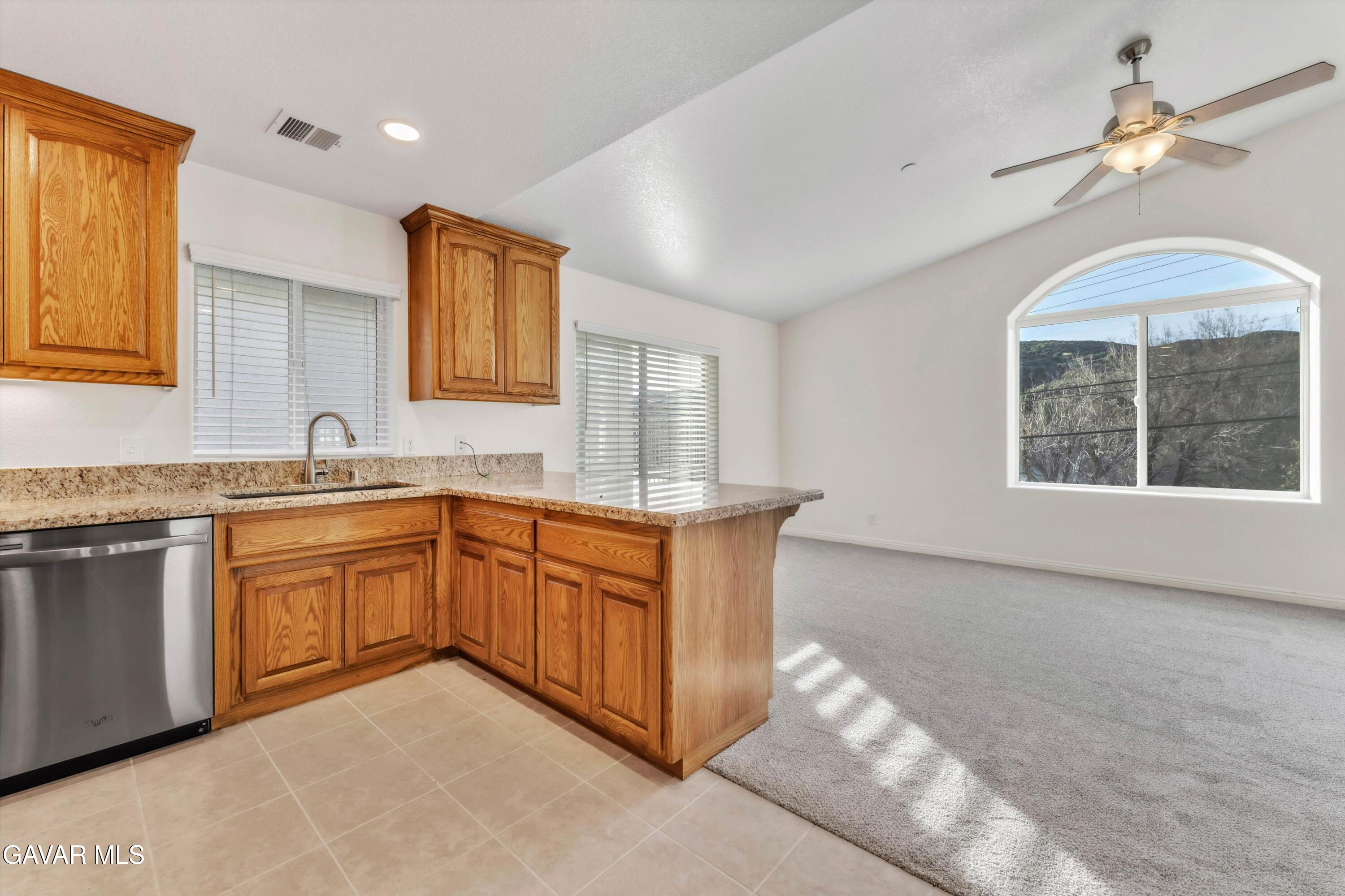 17819 Elizabeth Lake Road Lake Hughes, CA 93532 - Photo 2 of 28 a spacious bathroom with a granite countertop double vanity sink a window and a mirror