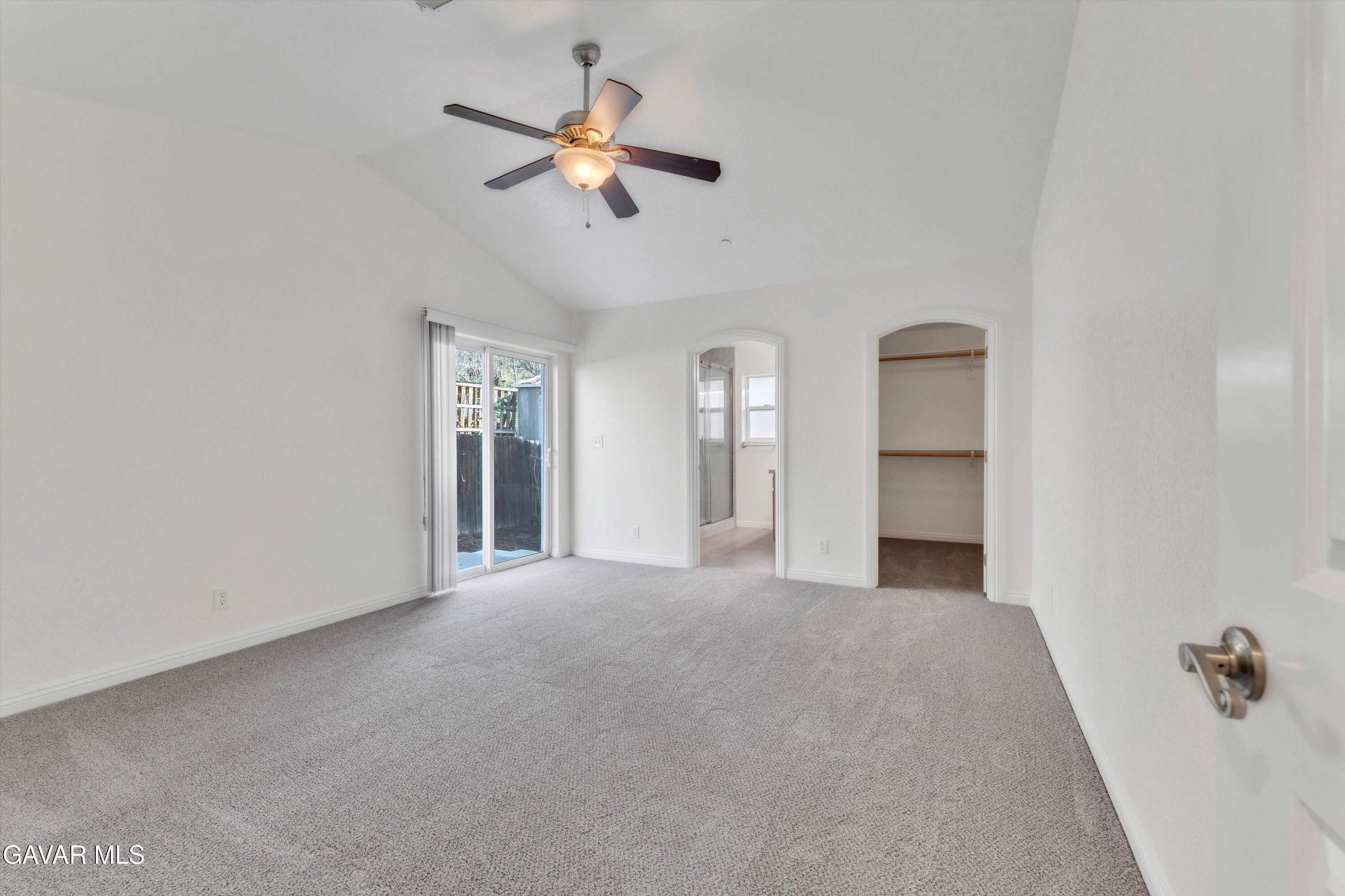 17819 Elizabeth Lake Road Lake Hughes, CA 93532 - Photo 22 of 28 an empty room with chandelier fan and windows