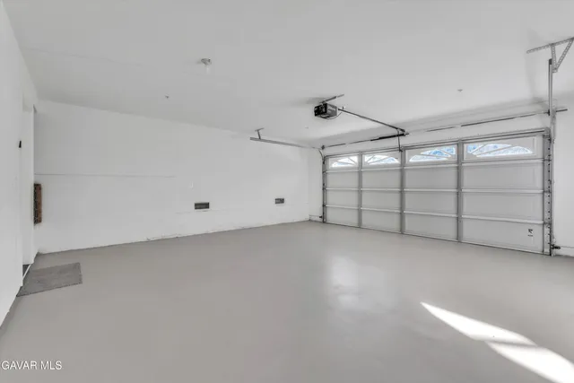 front view of a house with a yard and a pond