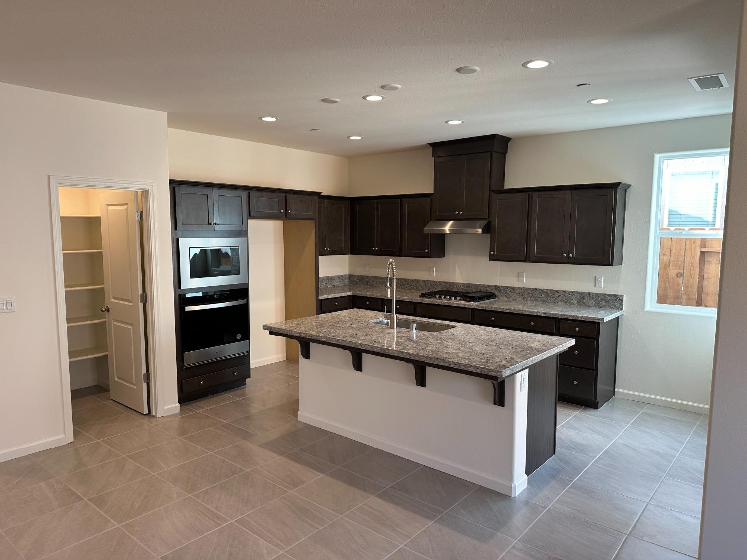 4171 Mitchell Avenue Clovis, CA 93619 - Photo 2 of 2 a kitchen with stainless steel appliances granite countertop a sink and a stove