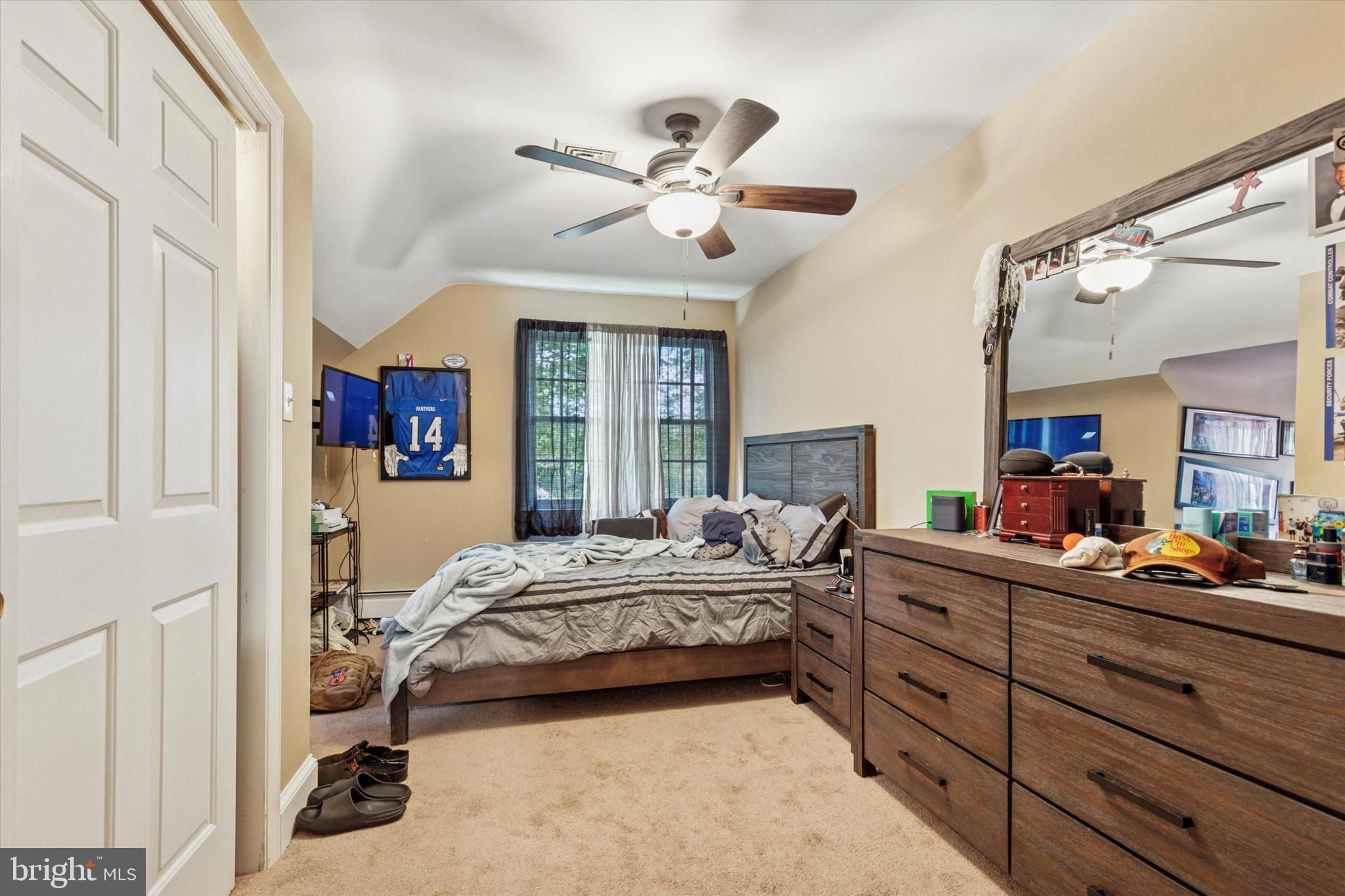 423 Deep Run Road Perkasie, PA 18944 - Photo 13 of 25 a bedroom with a bed and a chandelier