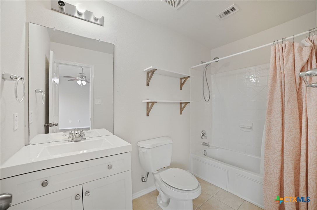 316 Housefinch Loop Leander, TX 78641 - Photo 28 of 37 Secondary bathroom with vanity and tub/shower combo.