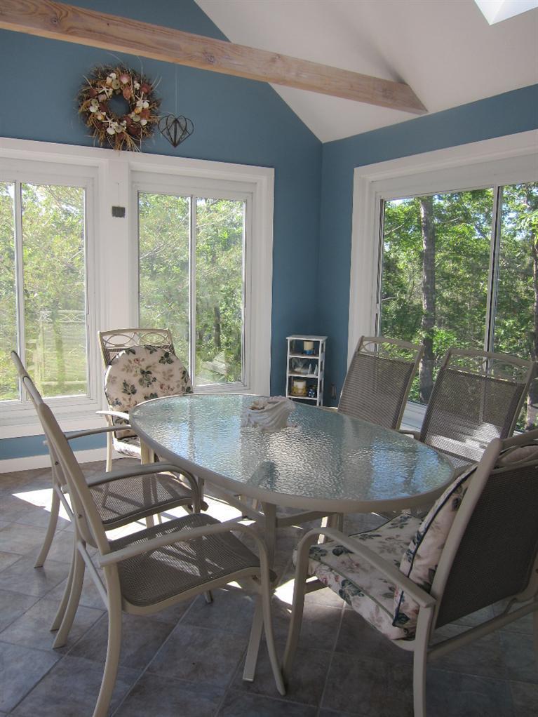 64 Pierces Tavern Road Wellfleet, MA 02667 - Photo 3 of 20 a view of a dining room with furniture window and outside view