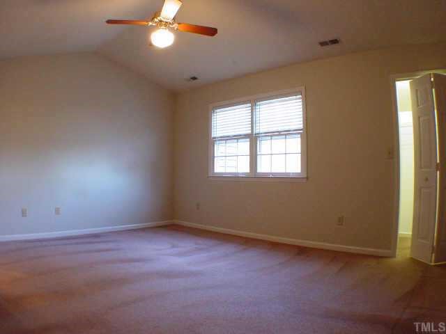 Master Bedroom with ceiling fan, vaulted ceiling, walk-in closet and private bath.