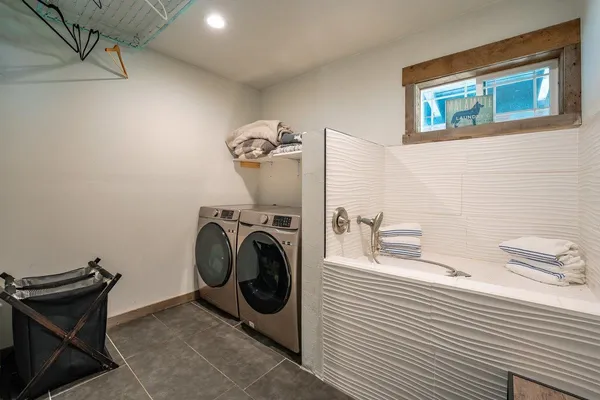a kitchen with a table chairs and a window
