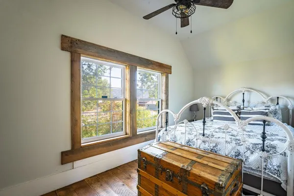 a living room with furniture a flat screen tv and a table