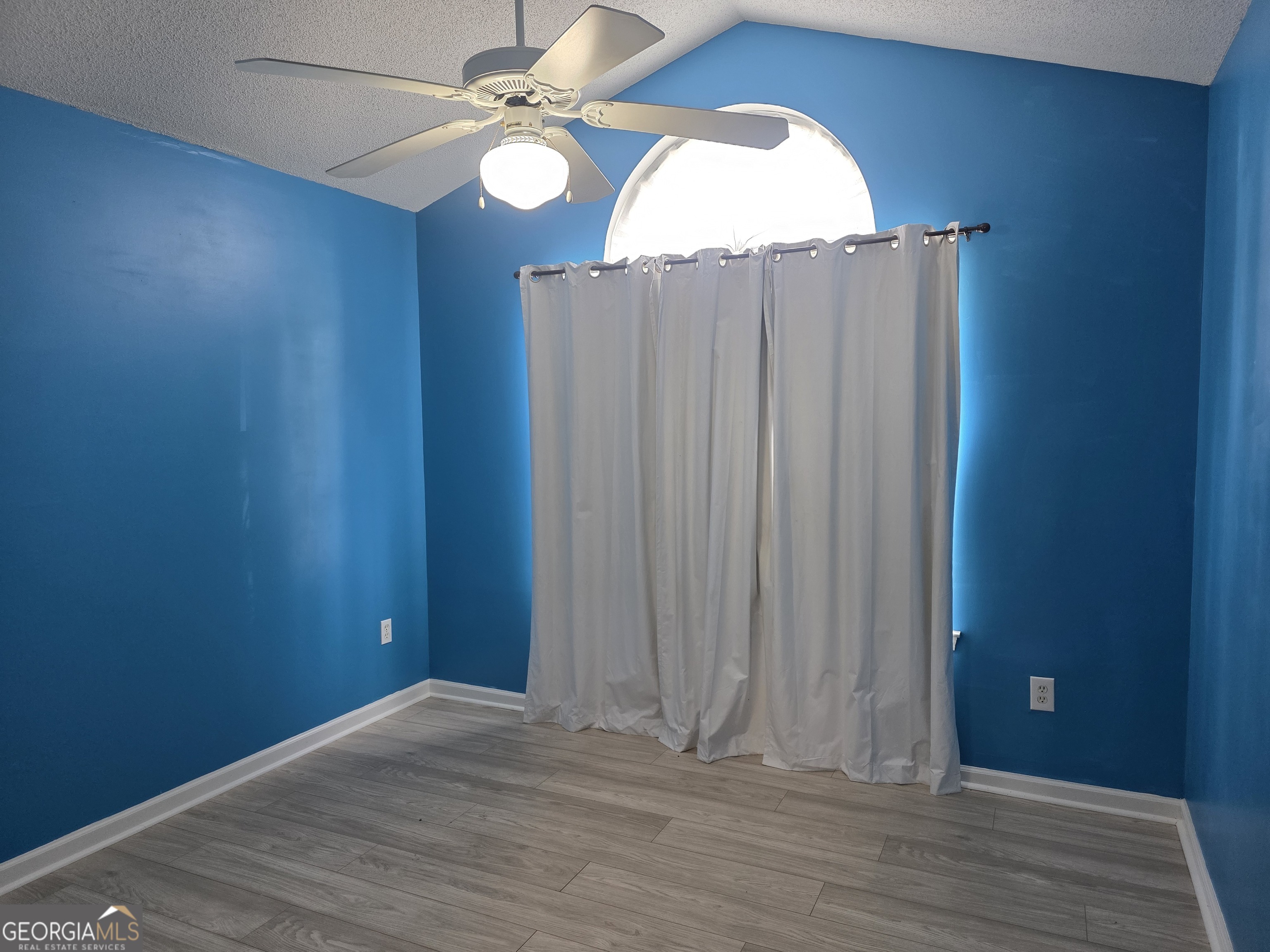 136 Towne Park Drive West Rincon, GA 31326 - Photo 13 of 24 an empty room with wooden floor fan and windows