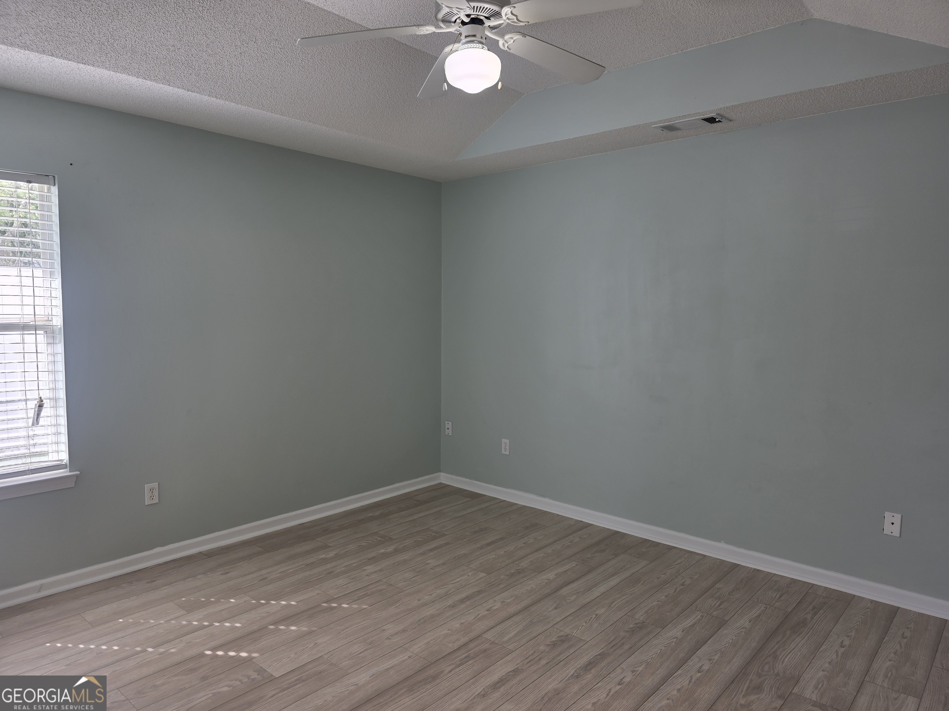 136 Towne Park Drive West Rincon, GA 31326 - Photo 17 of 24 wooden floor in an empty room with a window