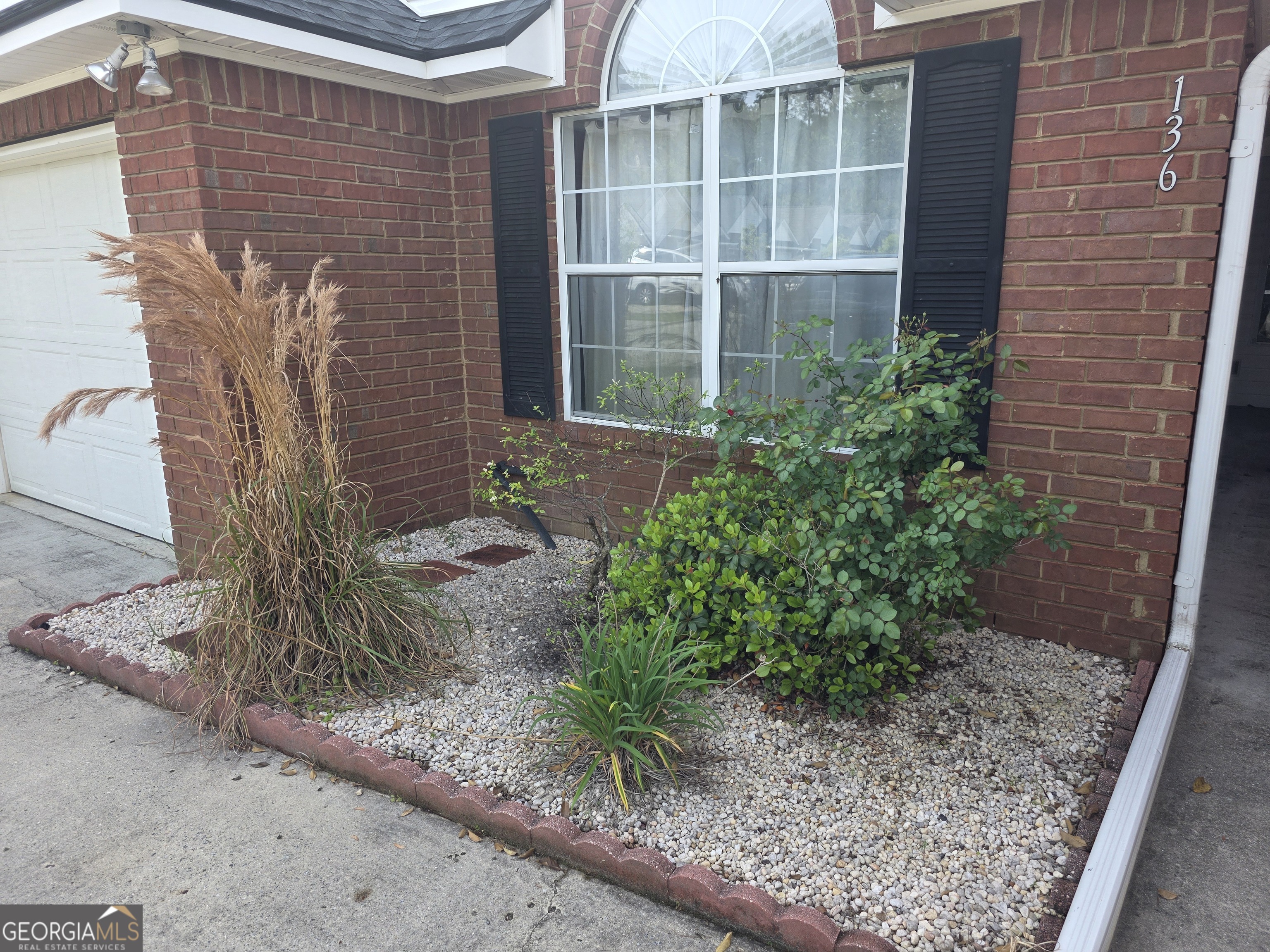 136 Towne Park Drive West Rincon, GA 31326 - Photo 2 of 24 a front view of a house with a garden