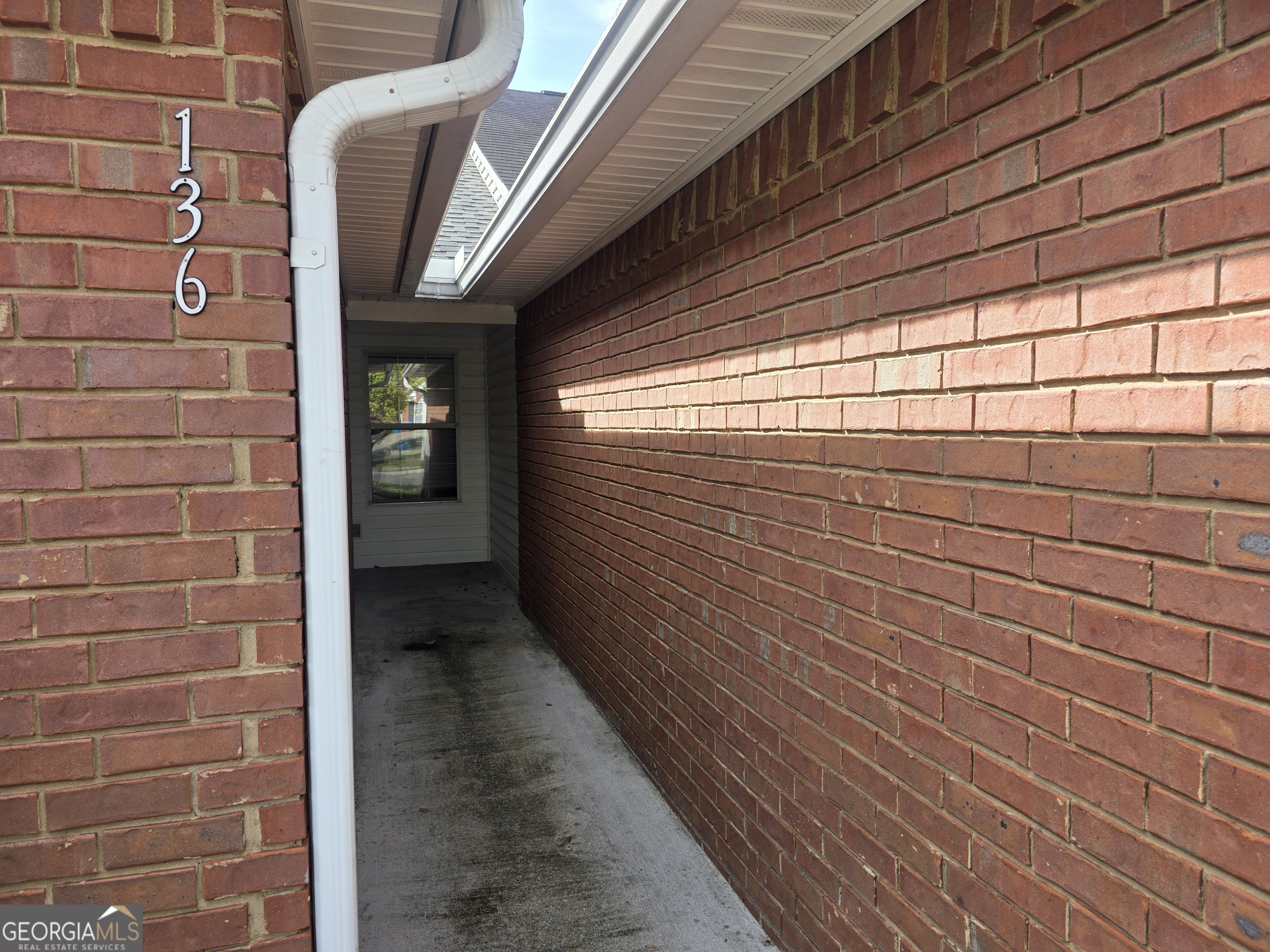 136 Towne Park Drive West Rincon, GA 31326 - Photo 3 of 24 a view of a pathway with a wall