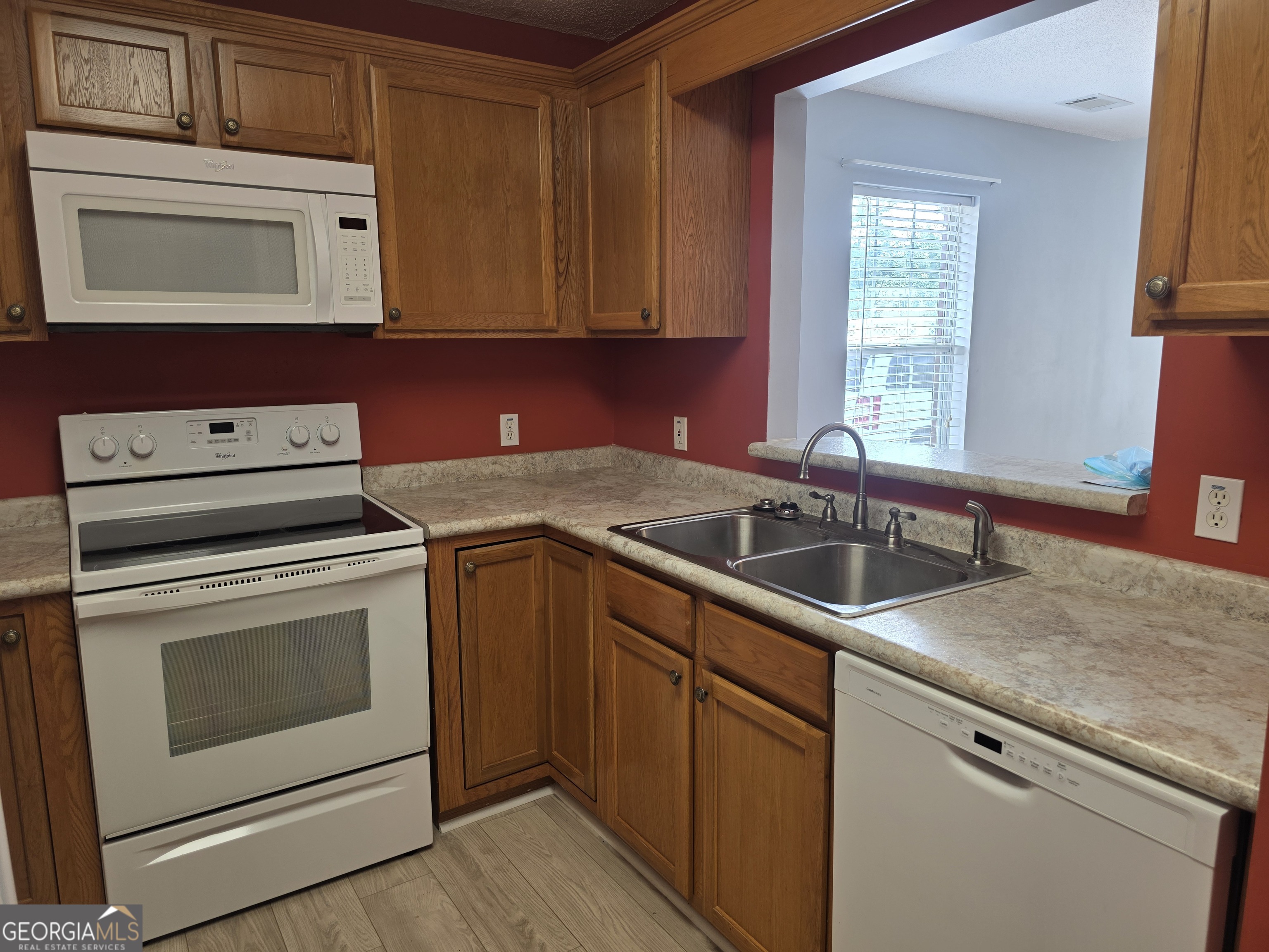136 Towne Park Drive West Rincon, GA 31326 - Photo 7 of 24 a kitchen with granite countertop a sink stove and microwave
