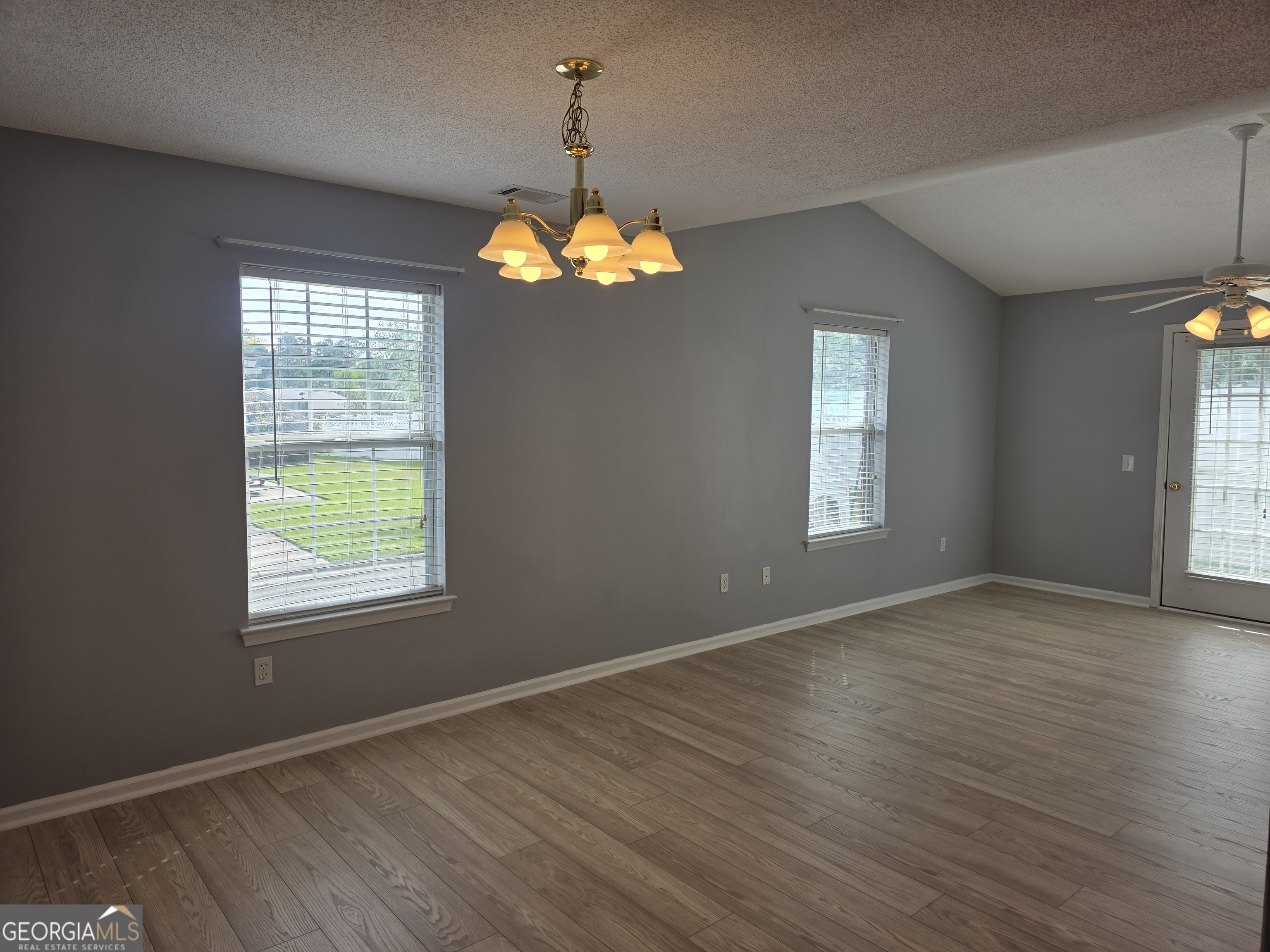 136 Towne Park Drive West Rincon, GA 31326 - Photo 9 of 24 an empty room with wooden floor and windows