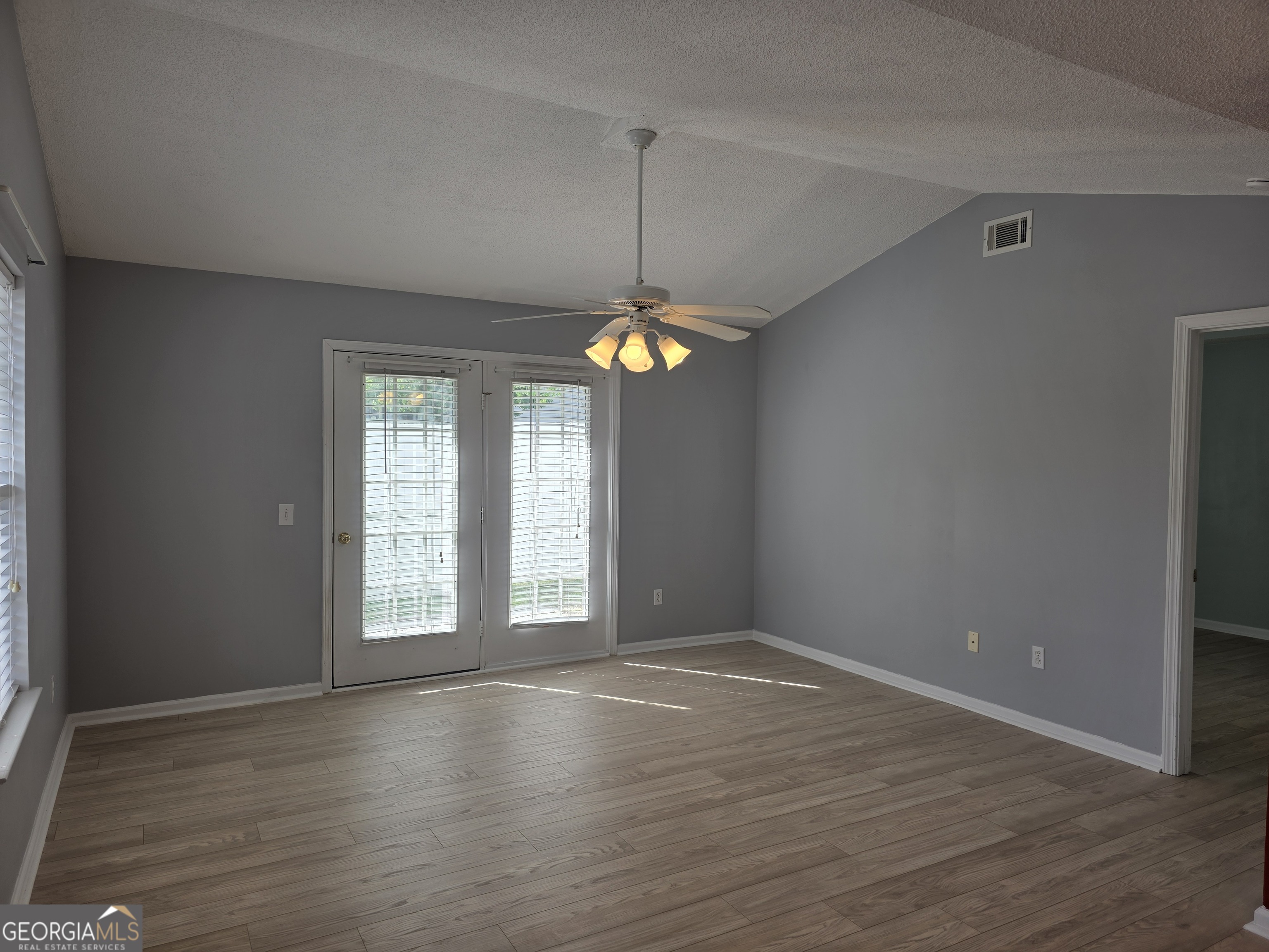 136 Towne Park Drive West Rincon, GA 31326 - Photo 10 of 24 an empty room with wooden floor and windows