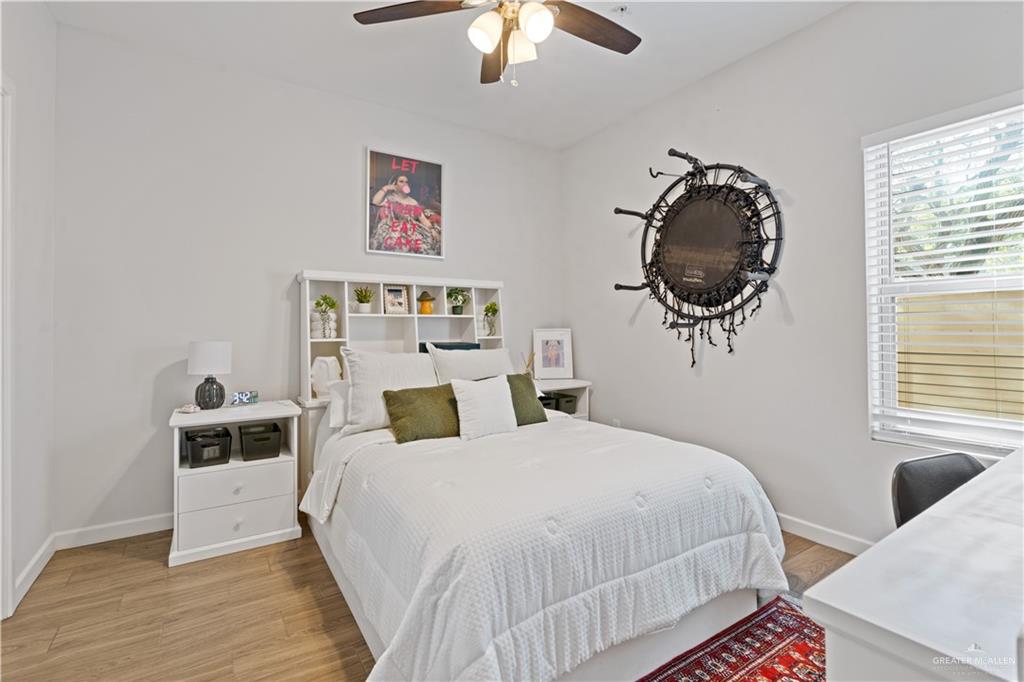 3020 South K Center Street, Unit 2 McAllen, TX 78503 - Photo 11 of 12 a bedroom with a bed and a chandelier